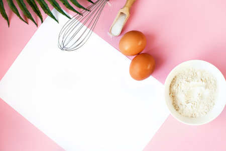 Ingredients for cooking baking - flour, egg, sugar, rolling pin on pink background. Concept of cooking dessert and sweet food.の写真素材