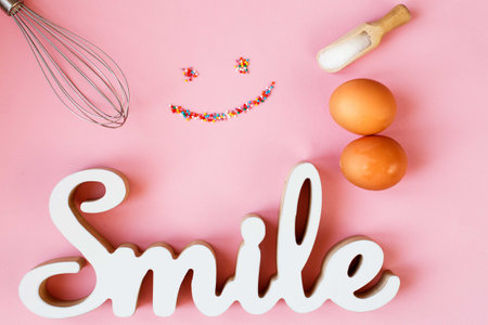 Ingredients for cooking baking - egg, sugar, rolling pin on pink background. Concept of cooking dessert and sweet foodの写真素材