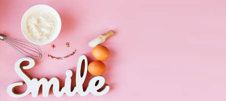 Ingredients for cooking baking - flour, egg, sugar, rolling pin on pink background. Concept of cooking dessert and sweet food. bannerの写真素材