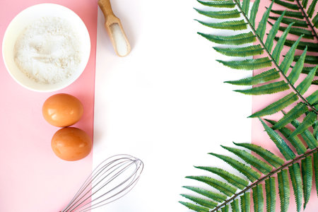 Ingredients for cooking baking - flour, egg, sugar, rolling pin on pink background. Concept of cooking dessert and sweet food.の写真素材