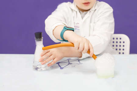 boy study science education in the class. Chemical laboratory with test tubes for experiments and multi-colored liquidsの写真素材