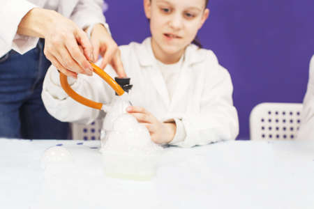 boy study science education in the class. Chemical laboratory with test tubes for experiments and multi-colored liquidsの写真素材