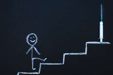 Drawn man on chalk board limbs up stairs tj the syringe vaccine. The queue to receive a vaccination...