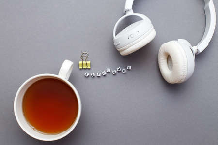 A cup of tea and word freelance made from plastic cubes of beads on a gray background with copy spaceの写真素材