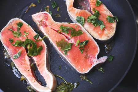 Raw trout steaks in a frying pan, top view.の写真素材