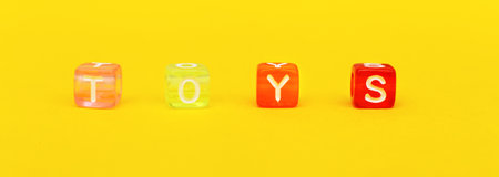 Word toys with colorful cubes of beads on a yellow background. bannerの写真素材