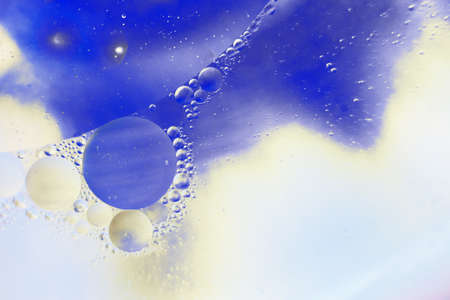 Oil bubbles close up. a circles of water macro. abstract light blue backgroundの写真素材