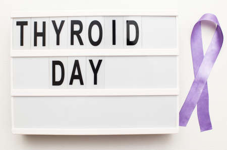 the inscription international thyroid day and violet ribbon on white backgroundの写真素材