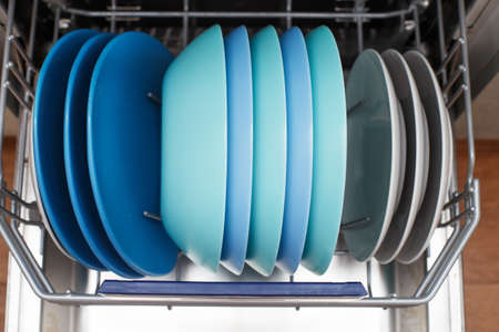 Open dishwasher with a clean dishes in the kitchen