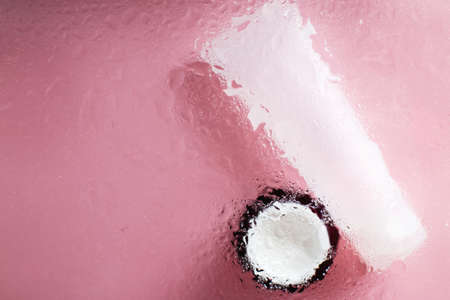 Concept of natural moisturizing skin care products. Face and hand cream under a glass surface with water on a pink background.の写真素材