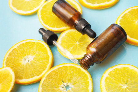 brown glass bottle with a pipette of face serum with vitamin C. Essential oil and orange slices. Health and beauty concept. Organic Natural Cosmetics.の写真素材
