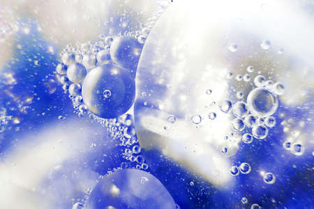 Oil bubbles close up. a circles of water macro. abstract light blue backgroundの写真素材