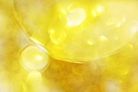 Gold Oil bubbles close up. a circles of water macro. abstract shiny light yellow backgroundの写真素材