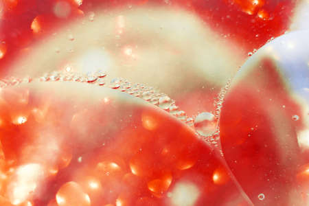 Oil bubbles close up. a circles of water macro. abstract orange and fiery red backgroundの写真素材