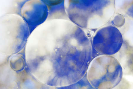 Oil bubbles close up. a circles of water macro. abstract light blue backgroundの写真素材