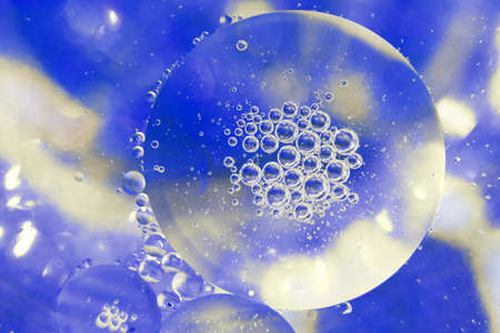 Oil bubbles close up. a circles of water macro. abstract light blue backgroundの写真素材