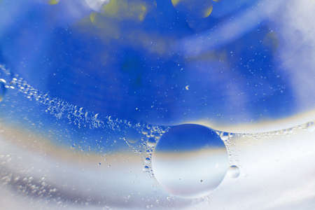 Oil bubbles close up. a circles of water macro. abstract light blue backgroundの写真素材