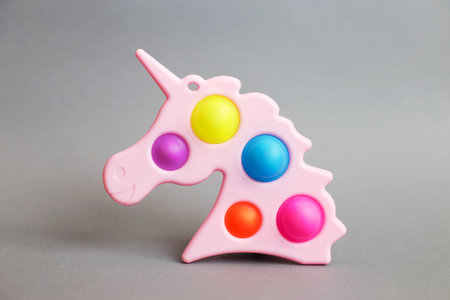 Simple dimple in the form of unicorn on a gray background.の写真素材