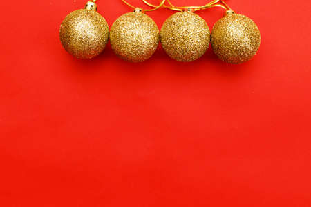 Gold Christmas balls on a red background.の写真素材