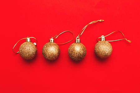 Gold Christmas balls on a red background.の写真素材