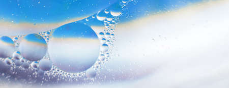 Oil bubbles close up. circles of water macro. abstract light blue background. bannerの写真素材