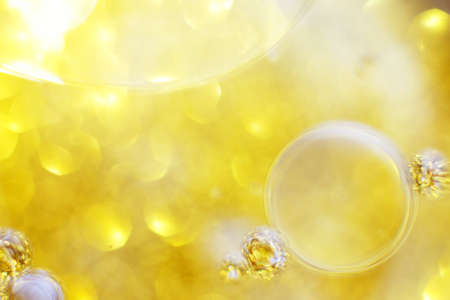 Gold Oil bubbles close up. circles of water macro. abstract shiny yellow backgroundの写真素材