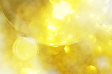 Gold Oil bubbles close up. circles of water macro. abstract shiny yellow backgroundの写真素材