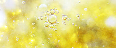 Gold Oil bubbles close up. circles of water macro. abstract shiny yellow background. bannerの写真素材
