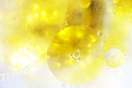 Gold Oil bubbles close up. circles of water macro. abstract shiny yellow backgroundの写真素材