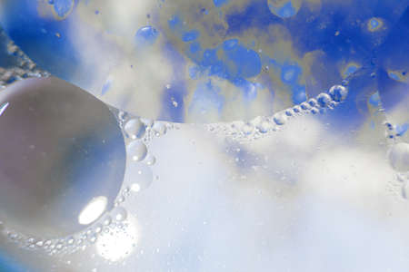Oil bubbles close up. circles of water macro. abstract light blue backgroundの写真素材