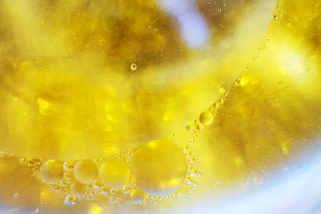 Gold Oil bubbles close up. circles of water macro. abstract shiny yellow backgroundの写真素材