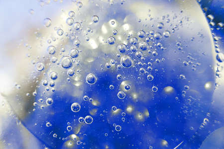 Oil bubbles close up. circles of water macro. abstract light blue backgroundの写真素材