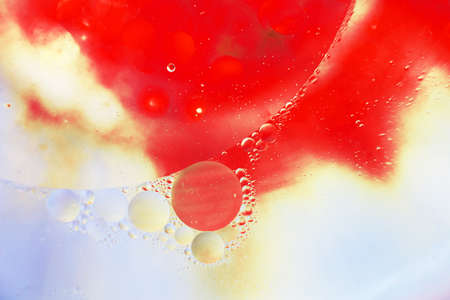 Oil bubbles close up. circles of water macro. abstract orange and fiery red backgroundの写真素材