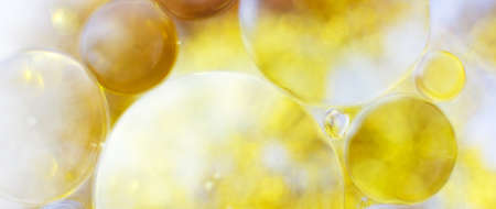 Gold Oil bubbles close up. circles of water macro. abstract shiny yellow background. bannerの写真素材