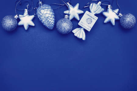 Gold Christmas balls and toys on a blue background.の写真素材