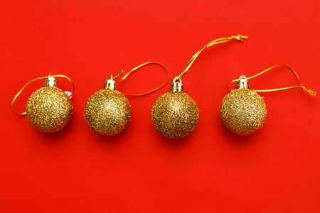 Gold Christmas balls on a red background.の写真素材