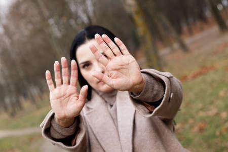 woman stretches her hands with open palms as a stop signの写真素材