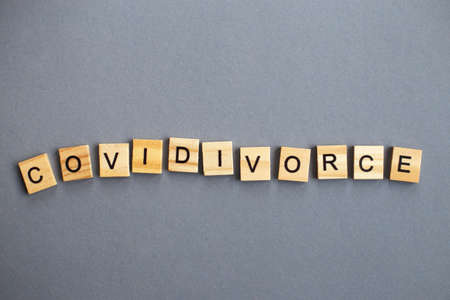 inscription covidivorce made by wooden blocks on gray background. broken family concept.の写真素材