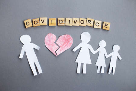 Paper chain cut family with broken heart on gray background. divorce in the covid pandemic.の写真素材
