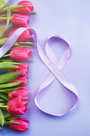 8 March card design with a pink tulips and ribbon in the shape of number eight. International...