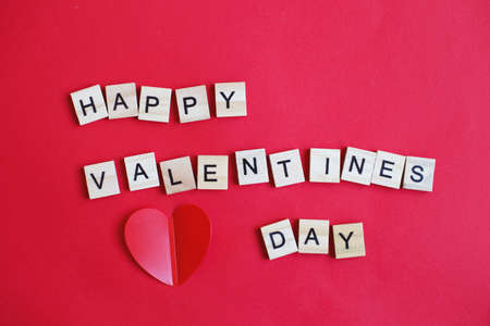 inscription happy Valentine's day with hearts on a red backgroundの写真素材
