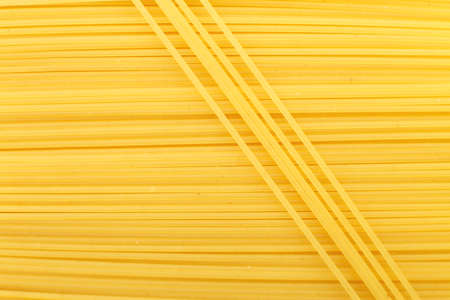 spaghetti yellow background close. raw pasta macroの写真素材