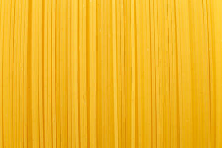 spaghetti yellow background close. raw pasta macroの写真素材