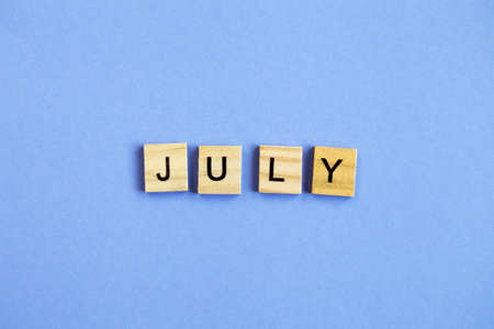 inscription July made by wooden cubes on a veri peri purple backgroundの写真素材