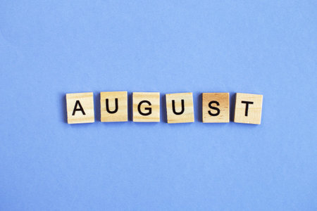 inscription August made by wooden cubes on a veri peri purple backgroundの写真素材