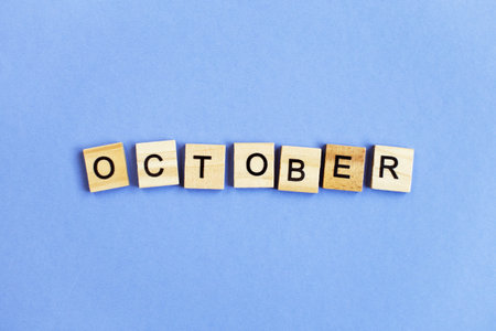 inscription October made by wooden cubes on a veri peri purple backgroundの写真素材