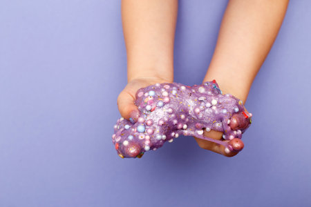 Making slime at home. child stretching colorful slime. DIY concept.の写真素材