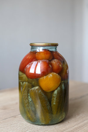 spoiled can of vegetable seaming. Glass jar with homemade pickled tomatos and cucumbers with white fungusの写真素材