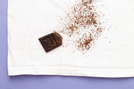 white clothes with ditry stains from chocolate on purple very peri background.の写真素材