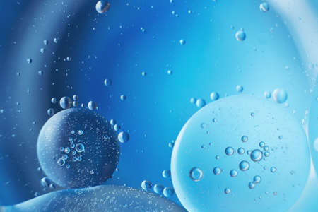 abstract light blue background with oil circles. bubbles of water close up. oil bubbles in the water...